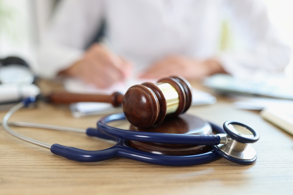 Wooden gavel and stethoscope on a desk representing personal injury law and medical claims