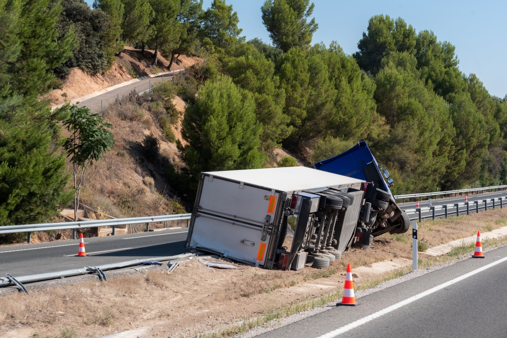 Overturned semi-truck on a rural Massachusetts highway, representing a commercial truck accident case in Clinton.