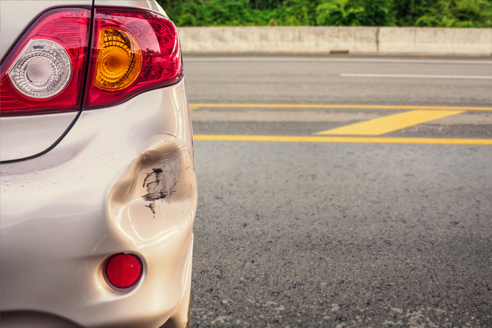Rear-end damage to a car after a hit-and-run accident on a Massachusetts roadway
