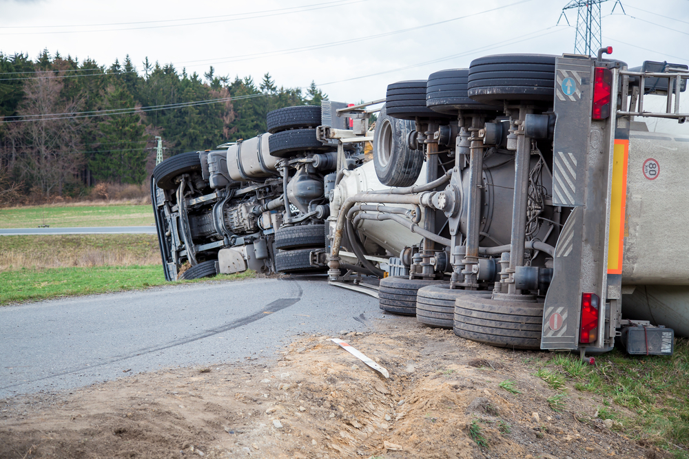 Overturned semi-truck on a roadway following a commercial vehicle accident