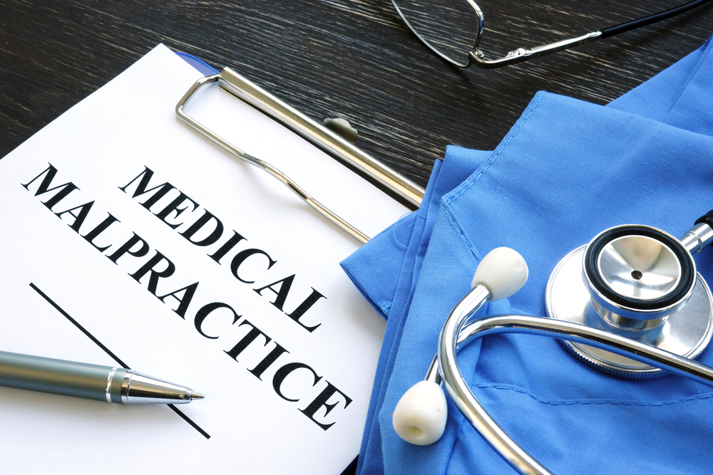 Medical malpractice claim document with stethoscope, representing investigation of healthcare errors in Massachusetts