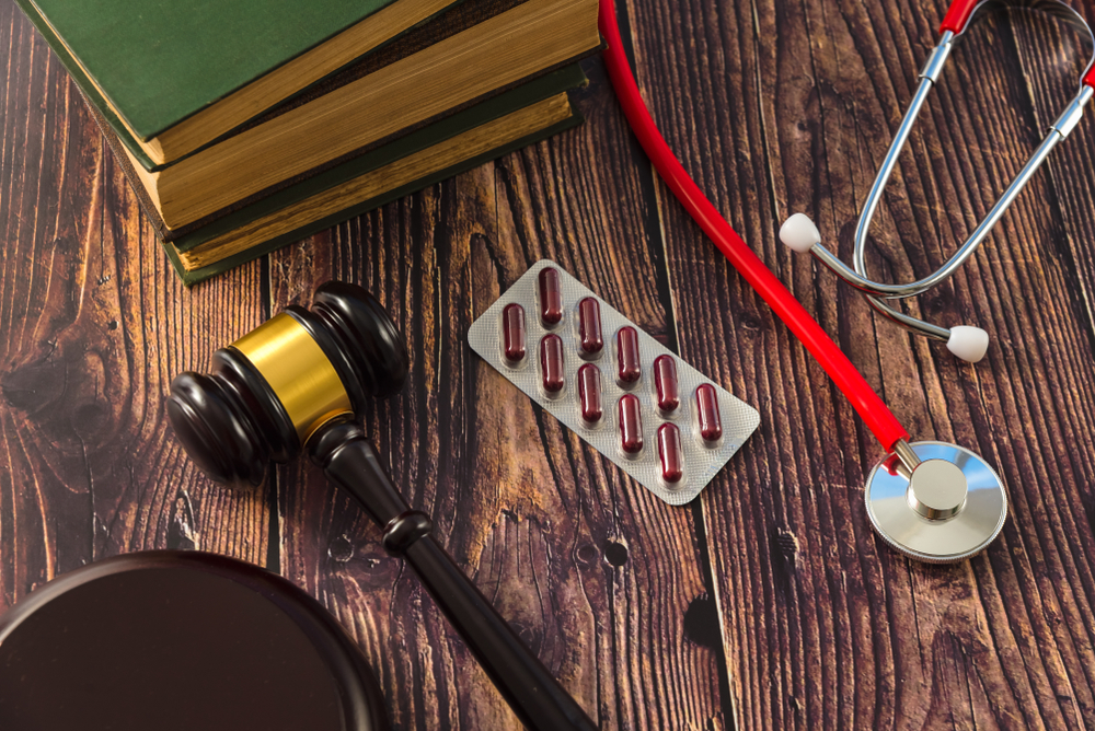 Gavel, prescription medication, and stethoscope symbolizing legal action related to medical negligence in Massachusetts.