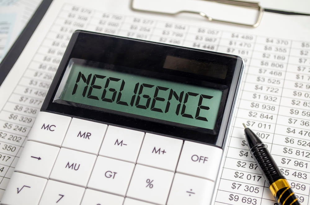 Calculator displaying negligence concept representing how comparative negligence affects injury settlements in Massachusetts