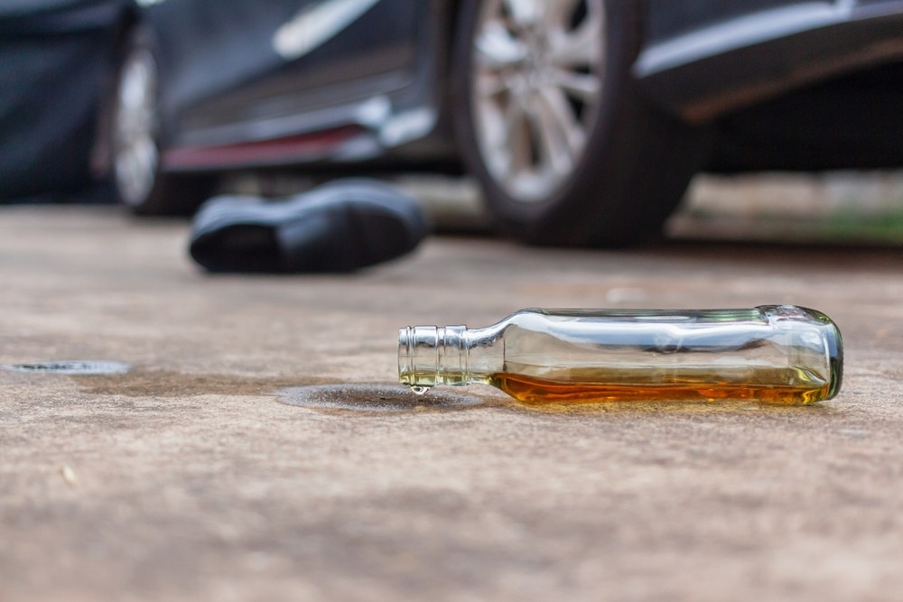 Alcohol bottle and personal belongings at a Massachusetts drunk driving crash scene